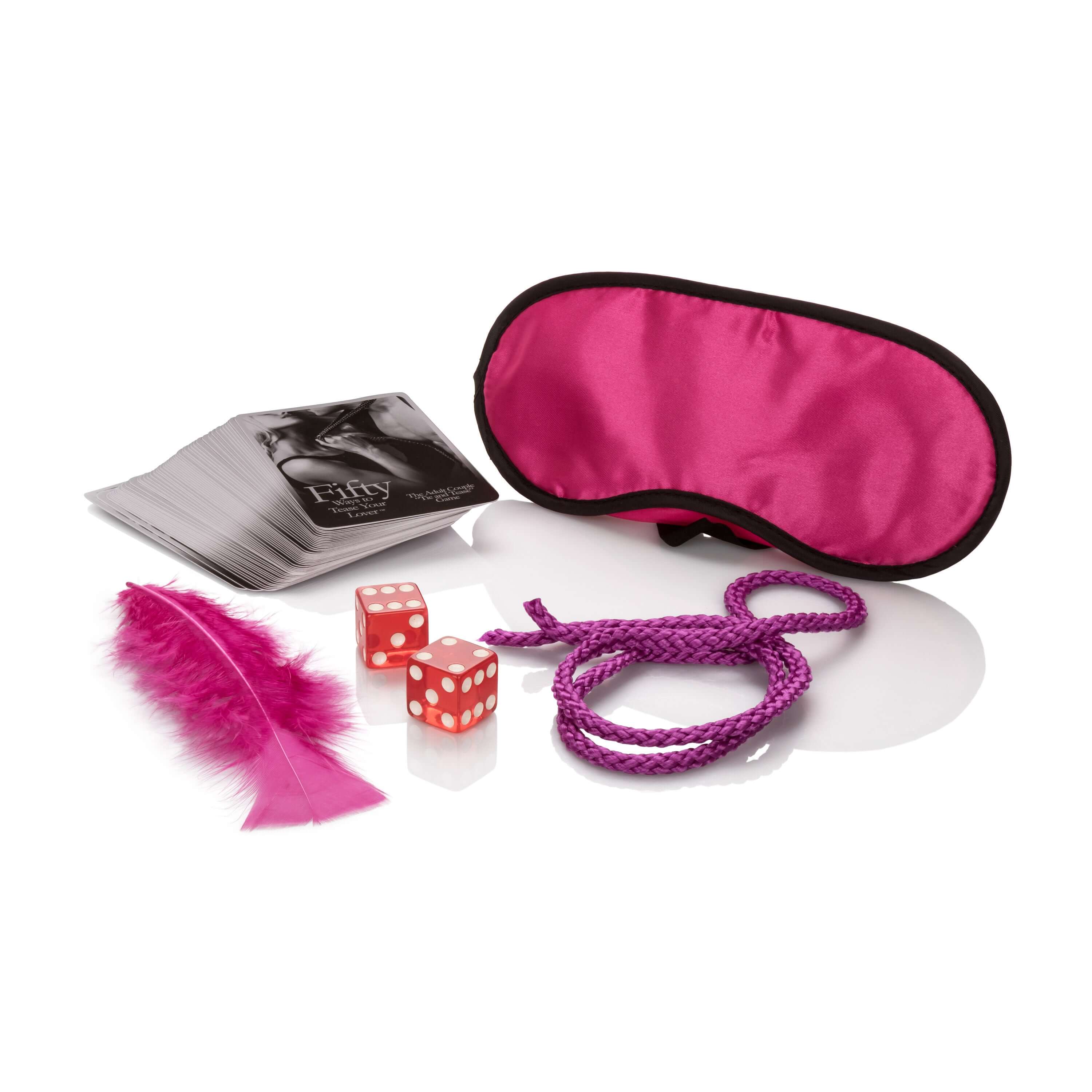 Image of the game Fifty Ways to Tease Your Lover including cards, dice, feather, blindfold, and rope.