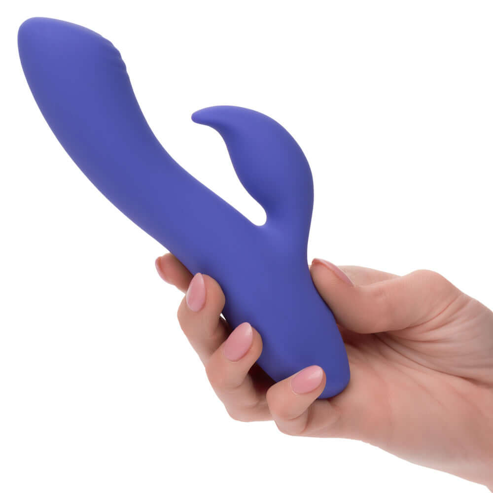 Hand holding CalExotics Connect Dual Stimulator in periwinkle blue, highlighting its dual motor design for versatile intimate play.