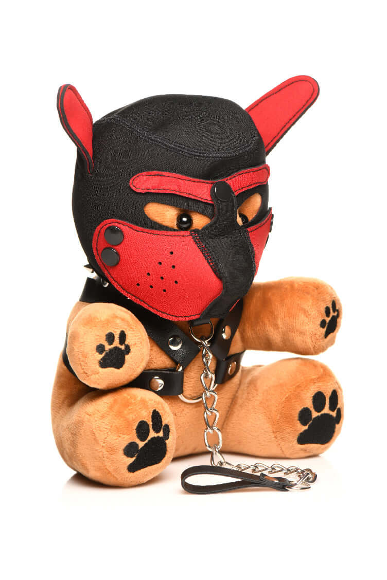 Plush Bondage Pup Bear with light peach fur, wearing a black and red puppy mask, faux leather harness with metal O-rings and a leash.