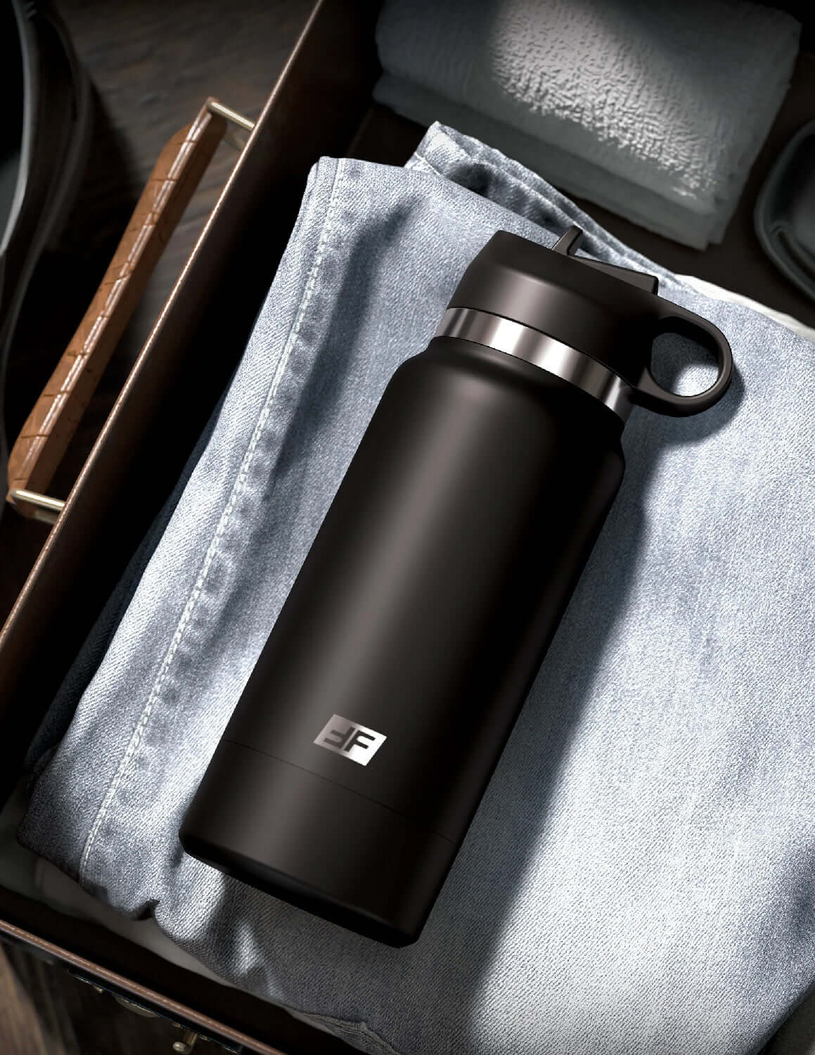 Fap Flask Thrill Seeker black frosted bottle disguised as a water bottle placed on folded jeans in a drawer, ideal for discreet use.