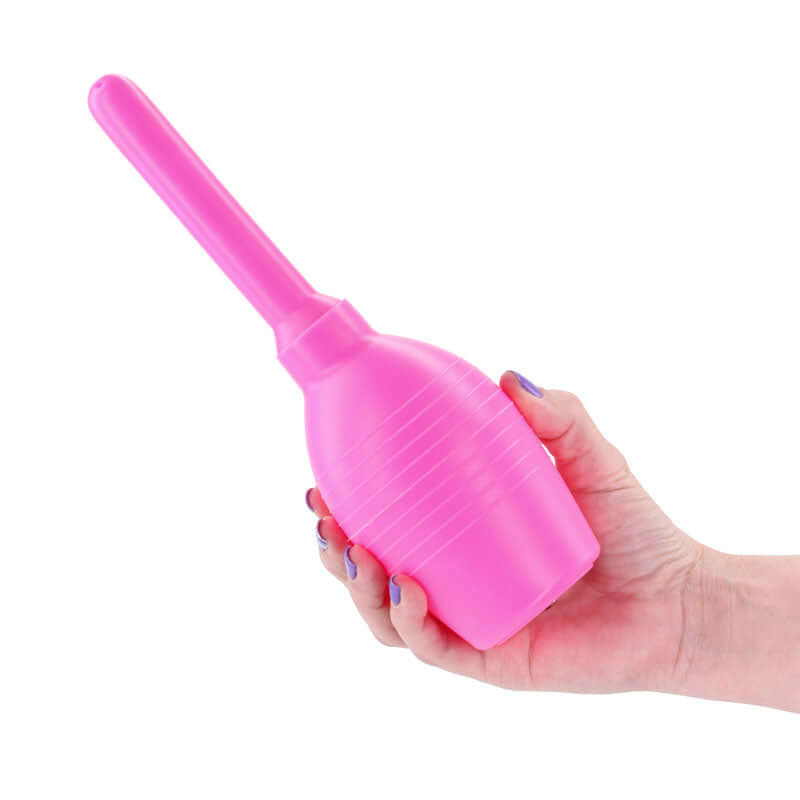 INYA Body Cleanser 2.0 Silicone Enema Pink held in a hand, showcasing ergonomic design and vibrant color.