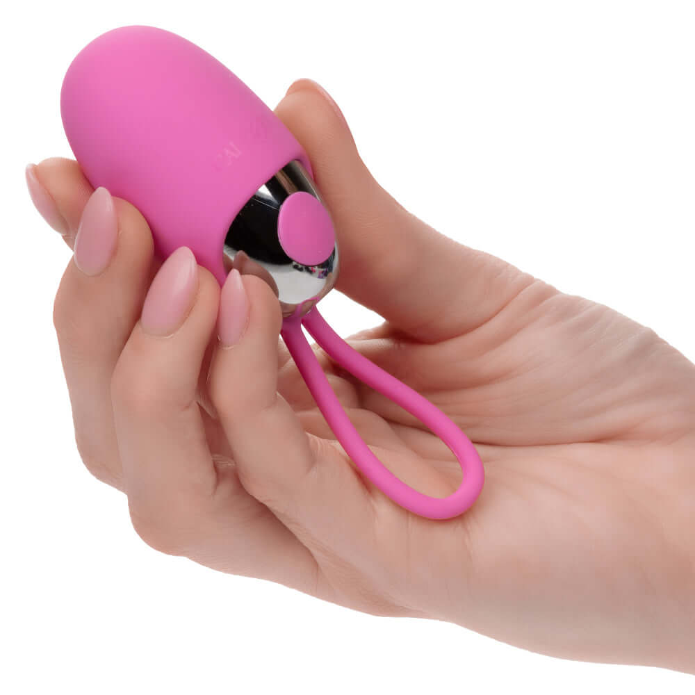 Hand holding pink Turbo Buzz Bullet with removable silicone sleeve designed for versatile and intense pleasure.