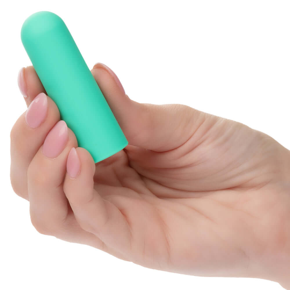 Close-up of a hand holding the Turbo Buzz Rounded Mini Bullet - Green, a small yet powerful stimulator with 10 vibration functions.