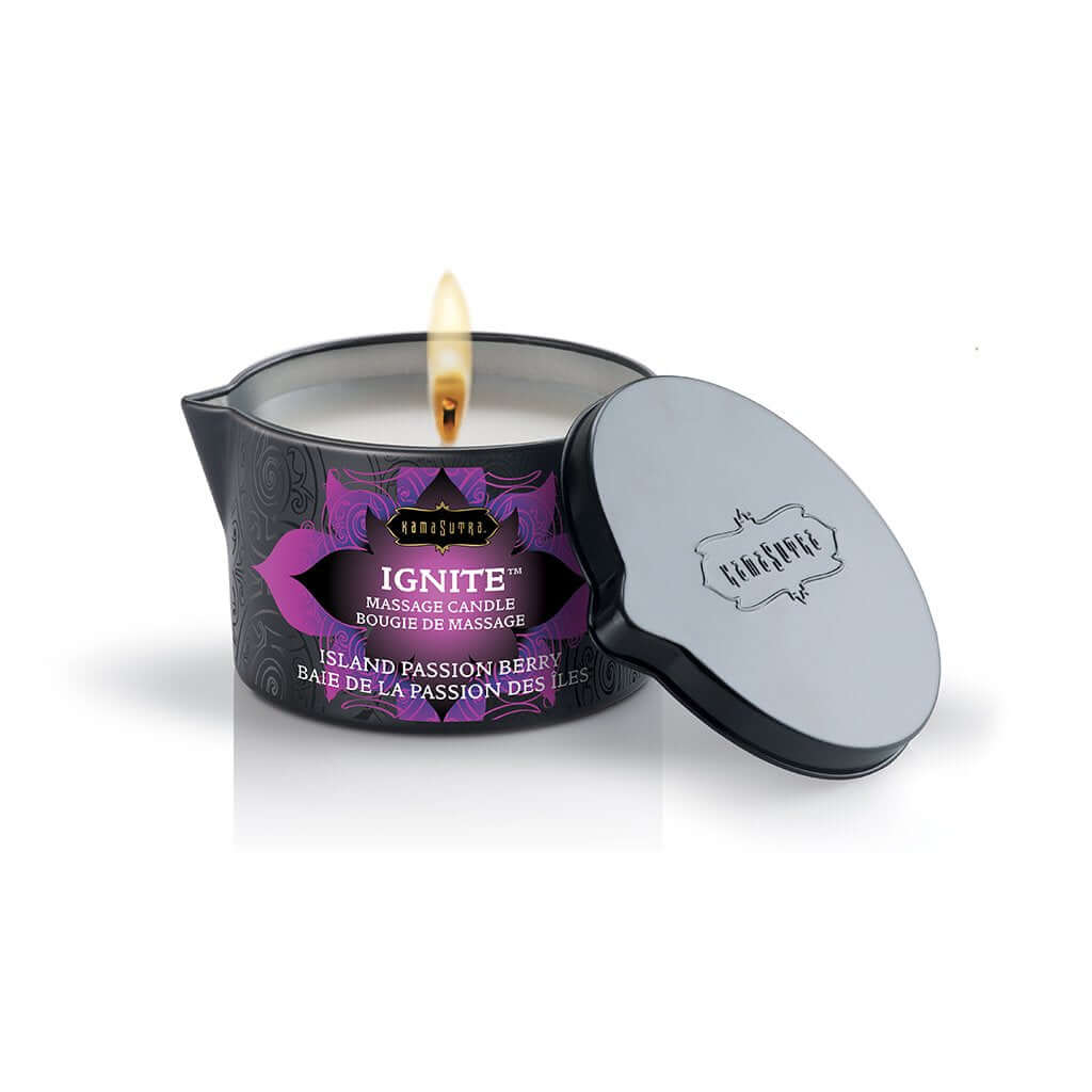 Kama Sutra Ignite Massage Candle Island Passion Berry 6 Oz with lit wick and decorative lid.