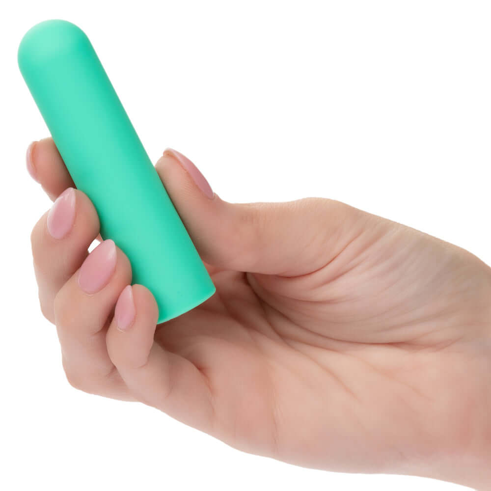 Hand holding Turbo Buzz Rounded Bullet stimulator in green color.