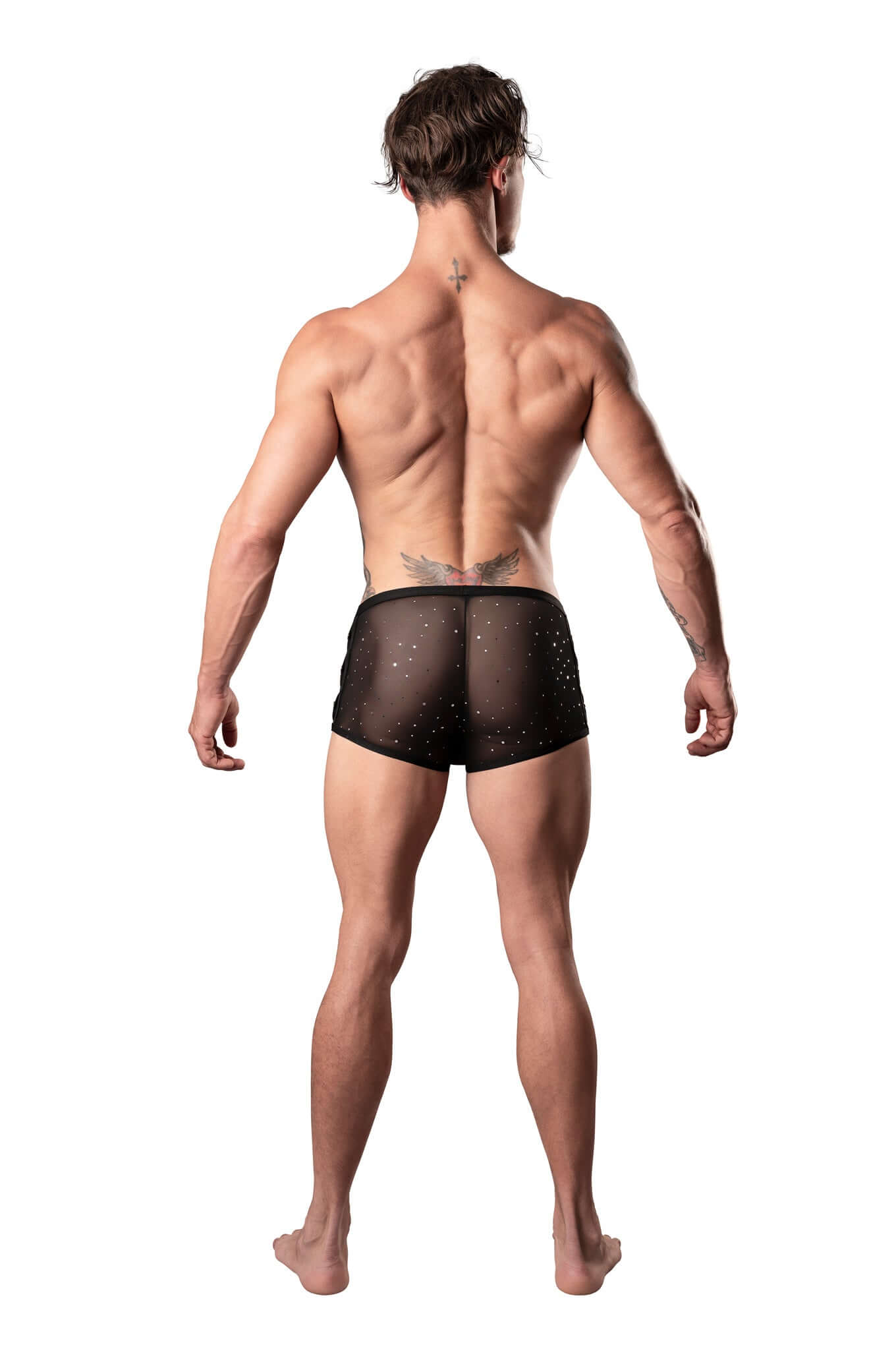 Male model wearing black mini shorts with silver dots and beading, showcasing low cut waist and high cut legs, back view.