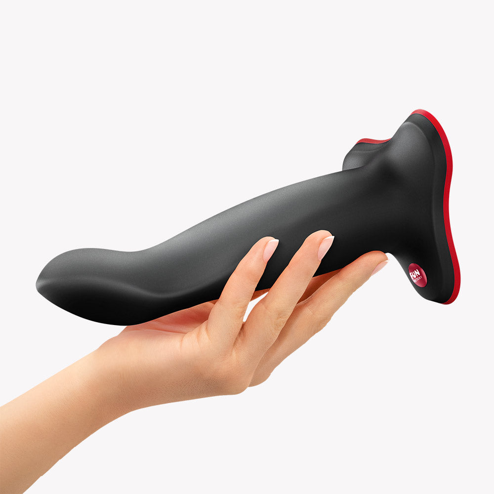 Fun Factory Limba Flex L Bendable Dildo Black being held in a hand, showcasing its flexible design for customized pleasure.