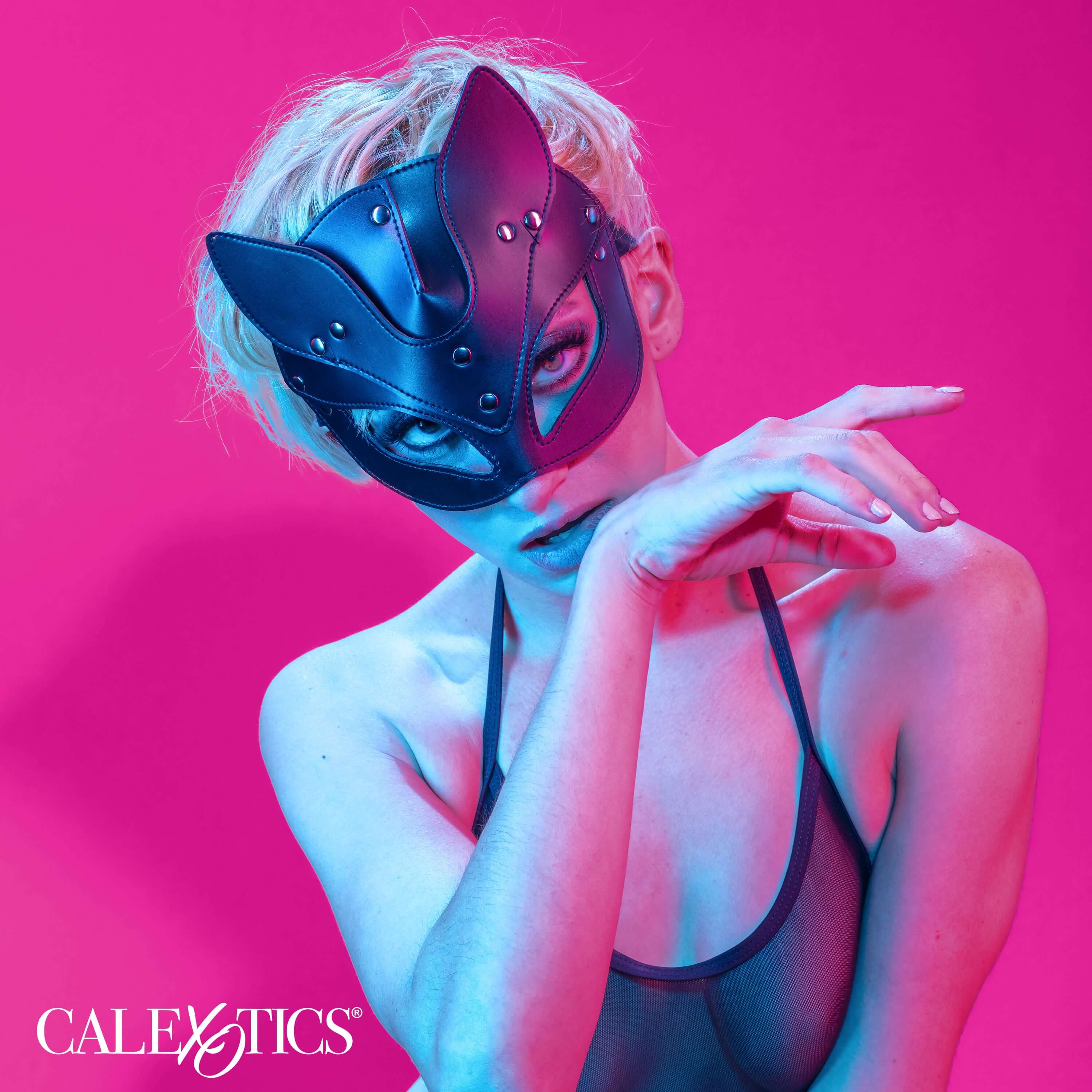 Euphoria Collection Cat Mask Black worn by a model, showcasing elegance and allure in a colorful setting.