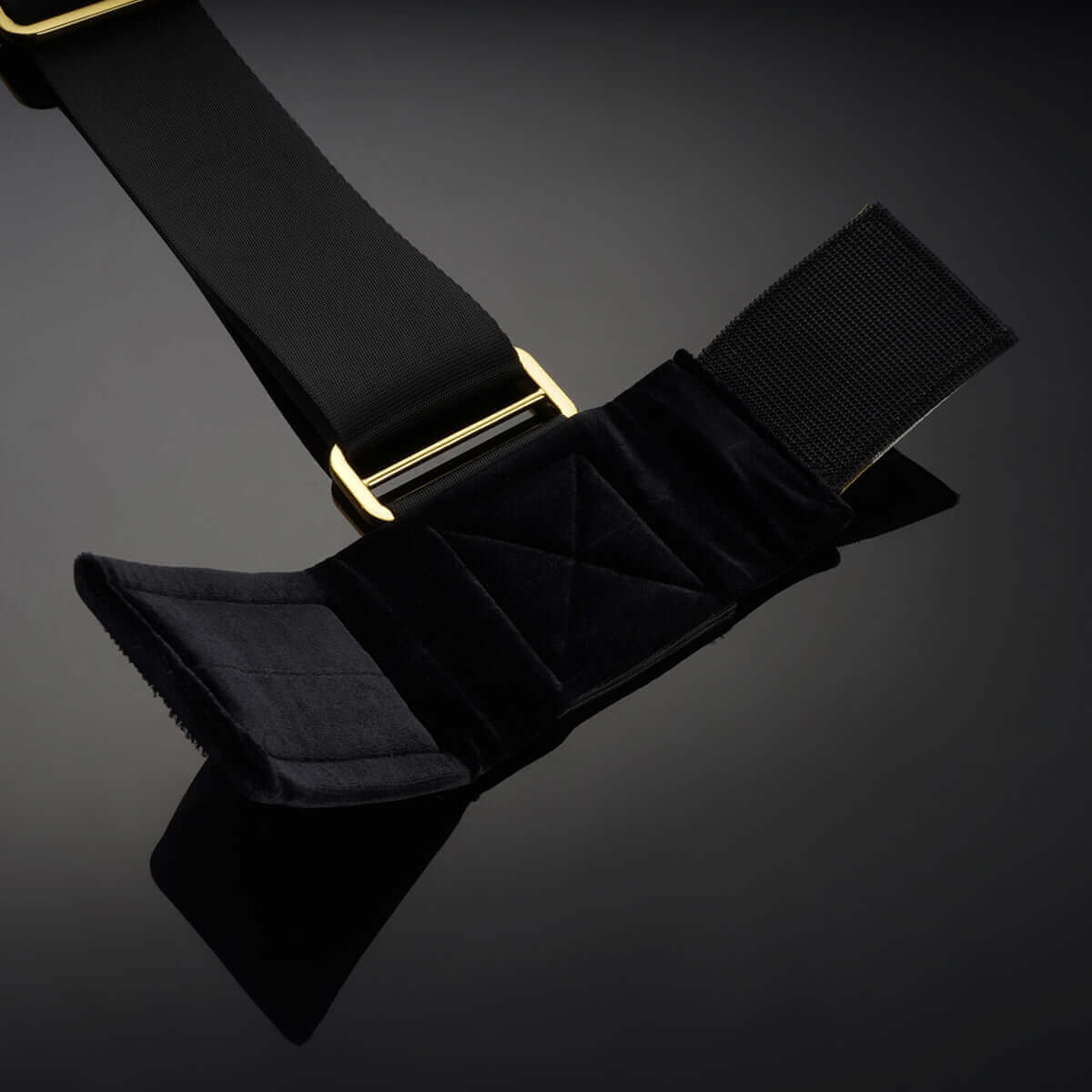 UPKO over-the-door hand restraint featuring soft velvet cuffs and sturdy black nylon straps with gold accents.