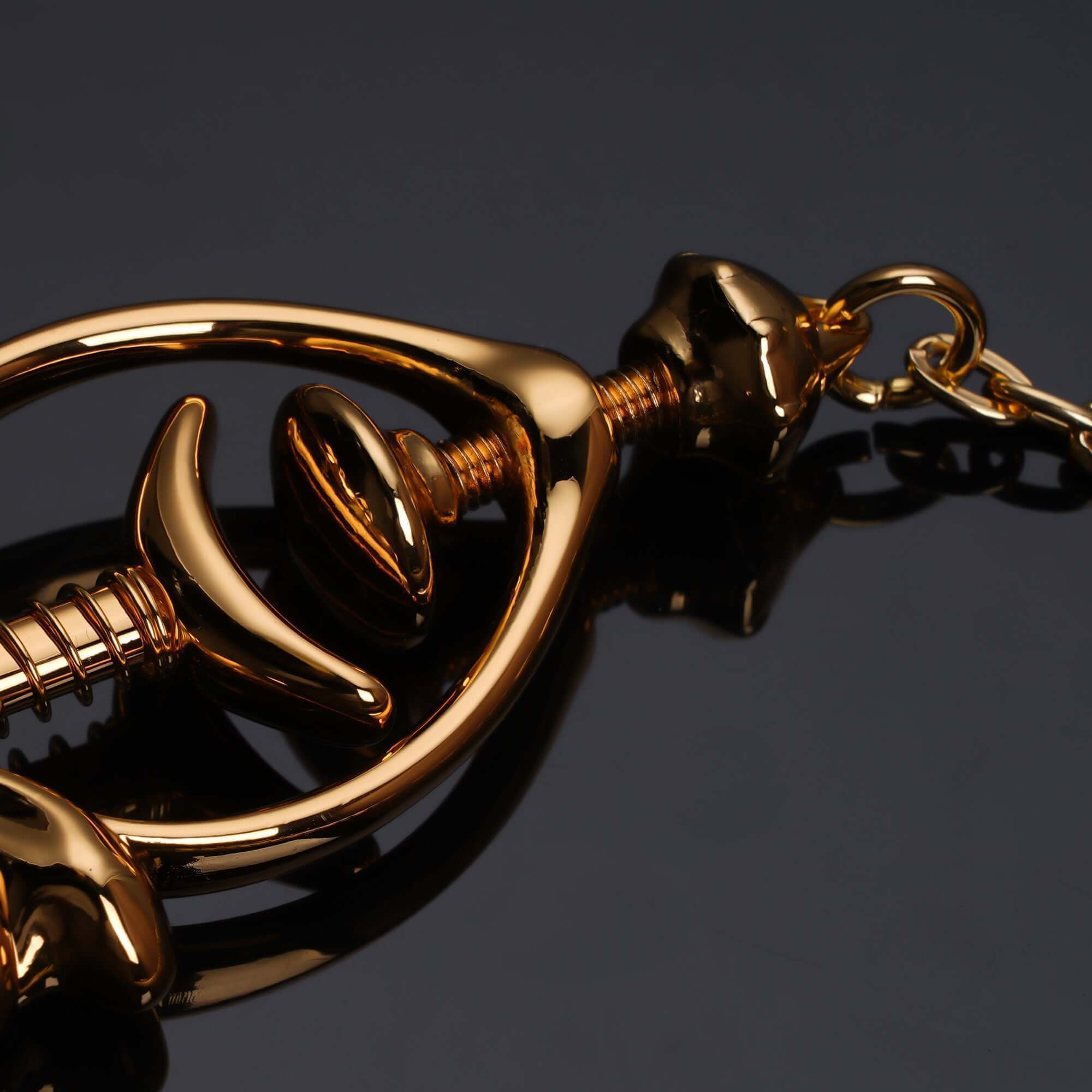 Close-up of elegant gold Pulling Chain Nipple Clamps featuring adjustable screws and curved design for comfort.