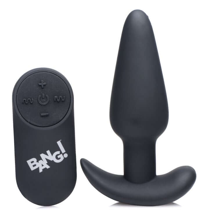 Bang 21x Silicone Butt Plug With Remote Black next to its remote control for pleasure.