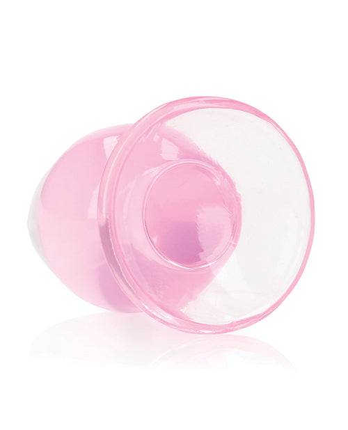 RealRock Crystal Clear 3.5 inch Anal Plug Pink shown from the side, featuring a smooth pink finish and a suction cup base.