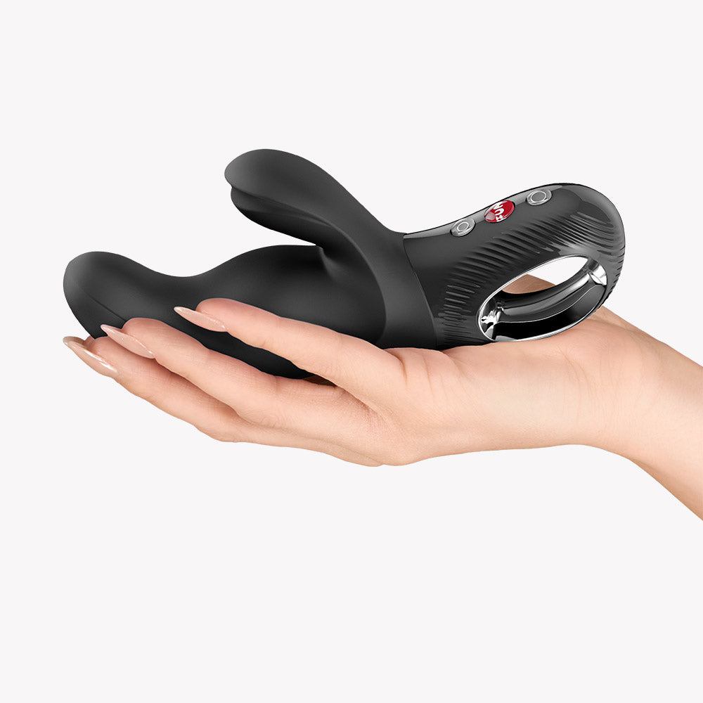 Fun Factory Miss Bi Rabbit Vibrator Black in a hand, showcasing its ergonomic design and dual stimulation features.