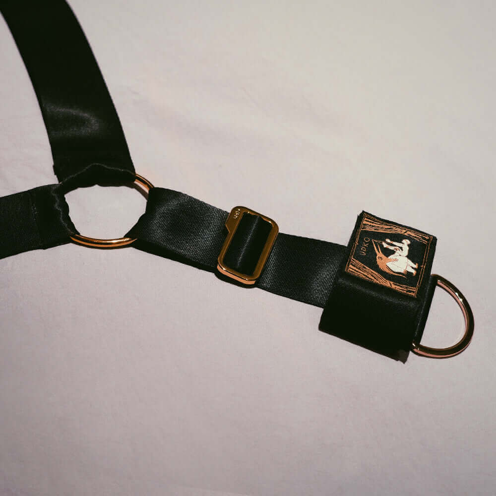 UPKO adjustable bed restraint strap featuring black satin material and gold accents for stylish BDSM adventures.