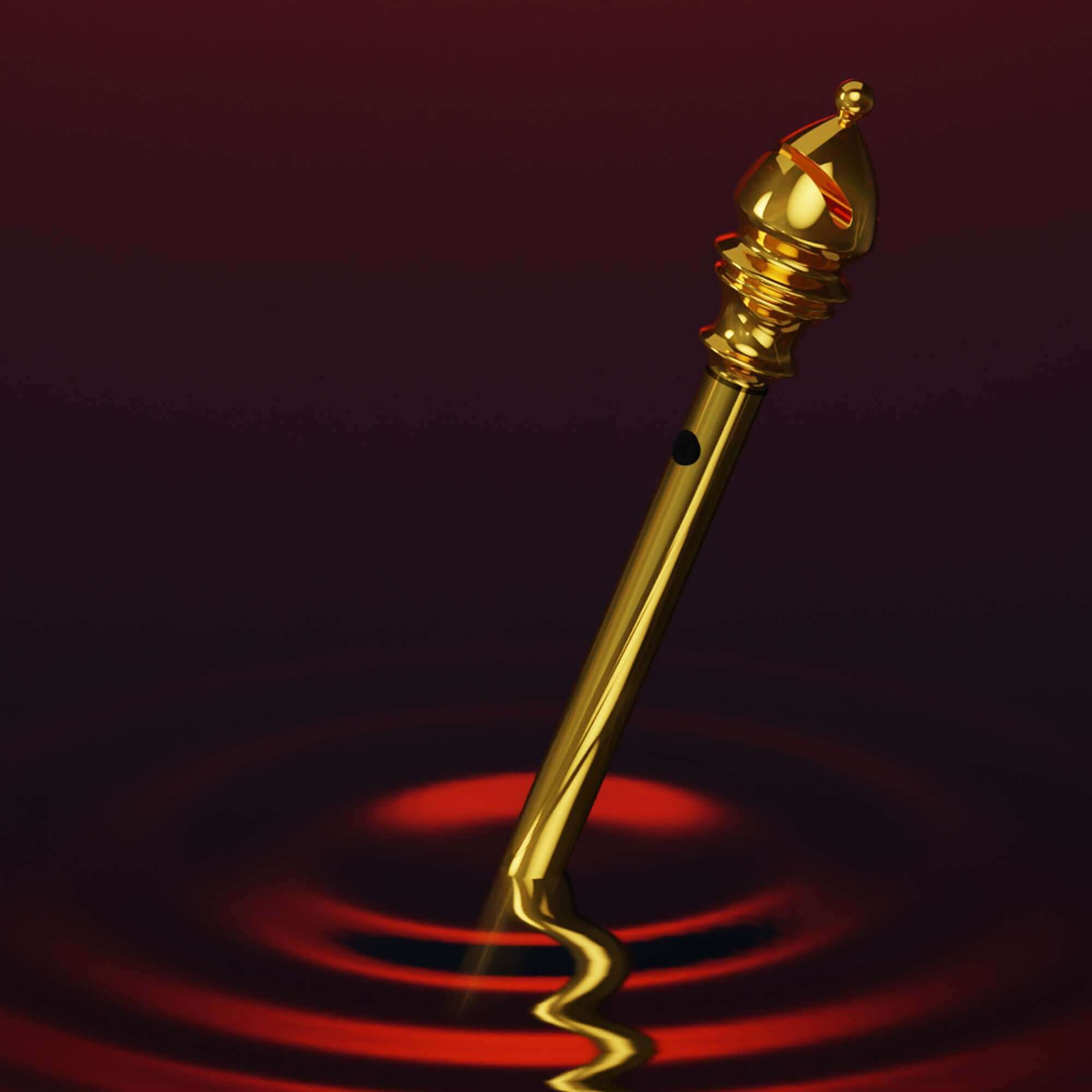 Golden mini vibrator from "The Chess" Collection creating ripples in a dark background, highlighting its compact design.