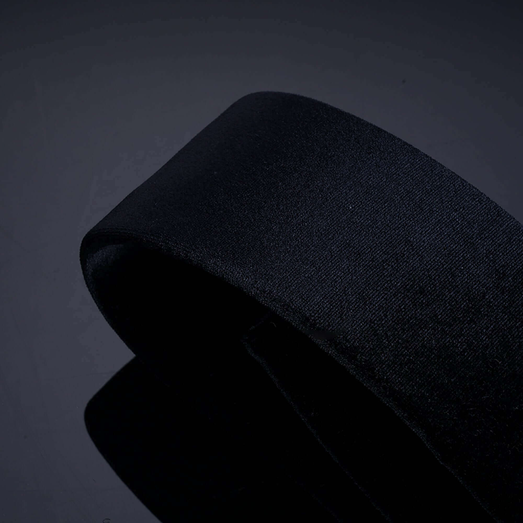 Close-up of a sleek black bondage restraint strap, highlighting its smooth texture and durability for versatile use.