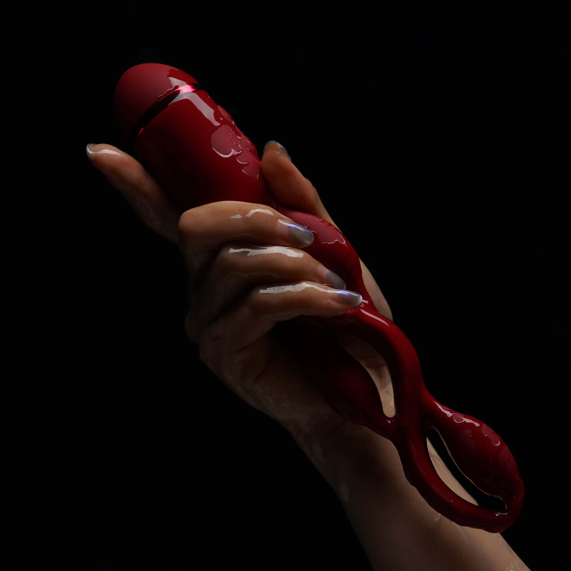 Hand holding UEROS Multi-motor Pulse Vibrator Red with unique design and pulse vibration mode for enhanced sexual experience.