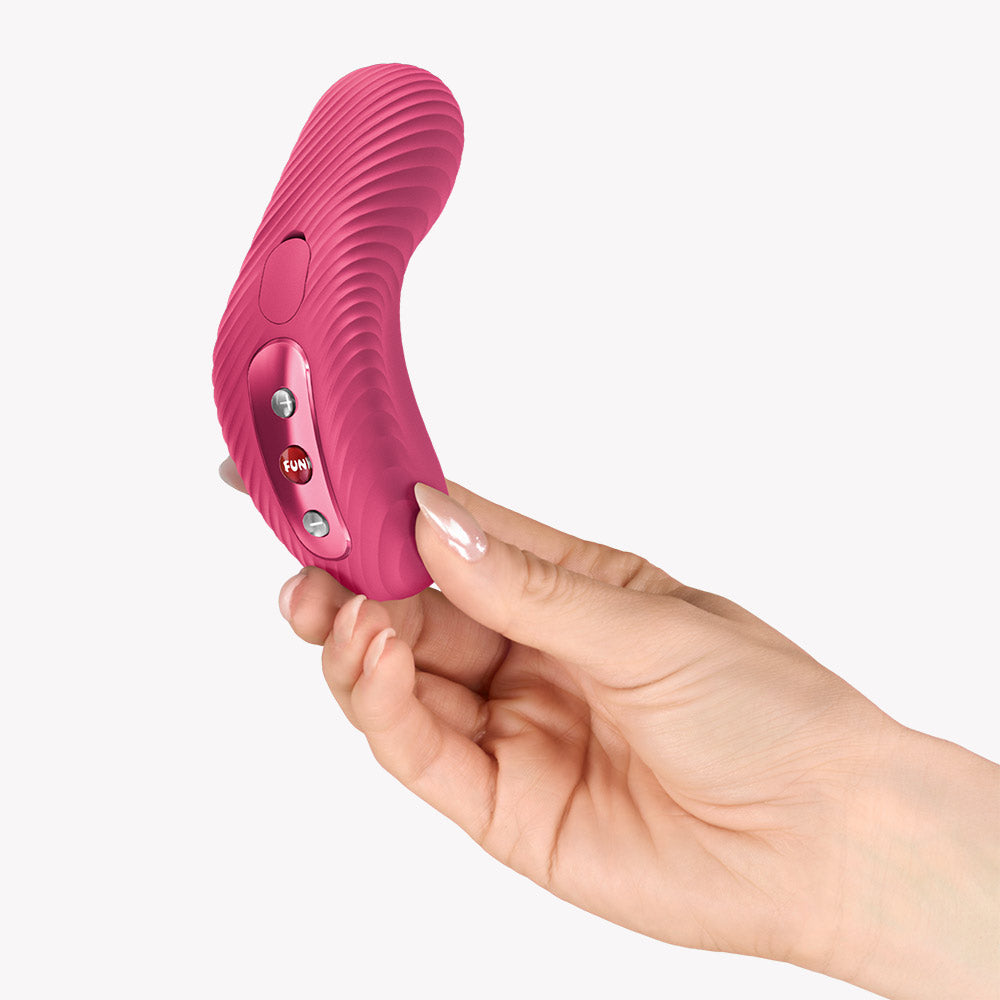 Fun Factory Laya III Lay-on Vibrator Magenta in hand showcasing ergonomic design and buttons.