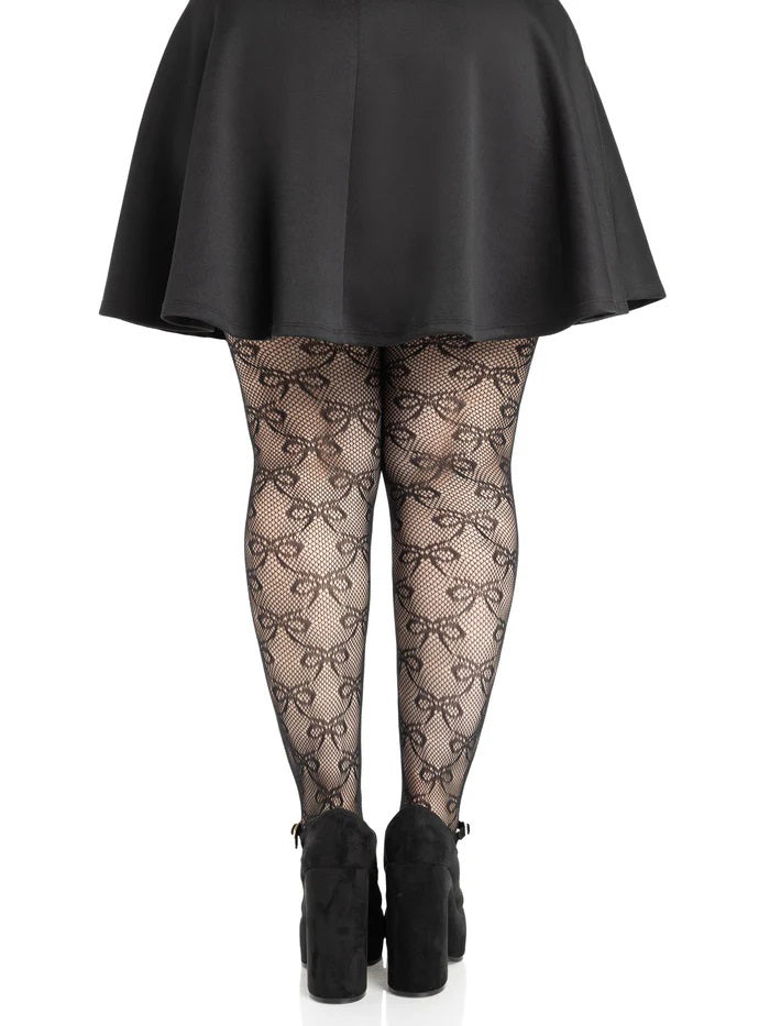 Leg Avenue Plus Size Bow Net Tights 1X 2X Black worn with a short black skirt, showcasing the elegant bow net pattern.