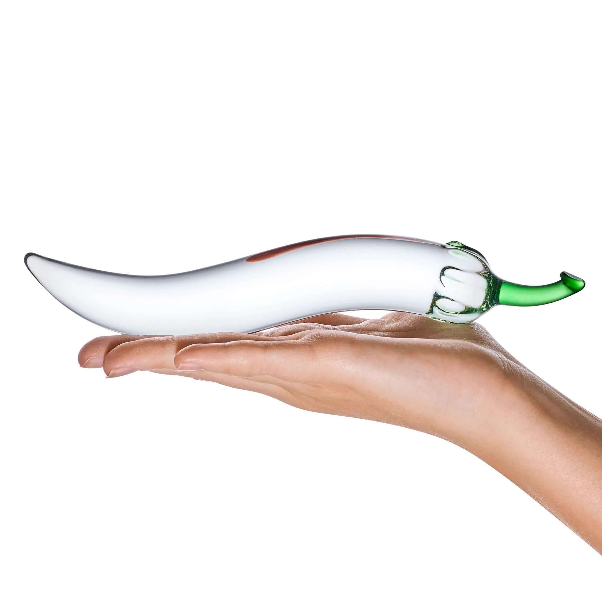 Woman's hand holding Glass Naturals Chili Pepper Dildo with green stem and curved silhouette for discreet pleasure.