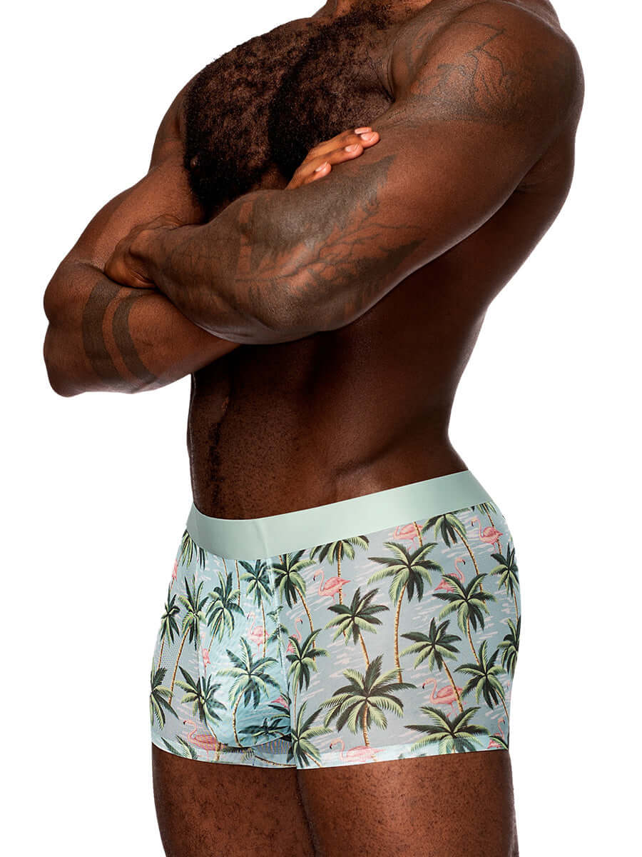 Close-up of a man wearing Sheer Prints seamless sheer shorts with a flamingo and palm tree pattern, showcasing comfortable waistband and fit.