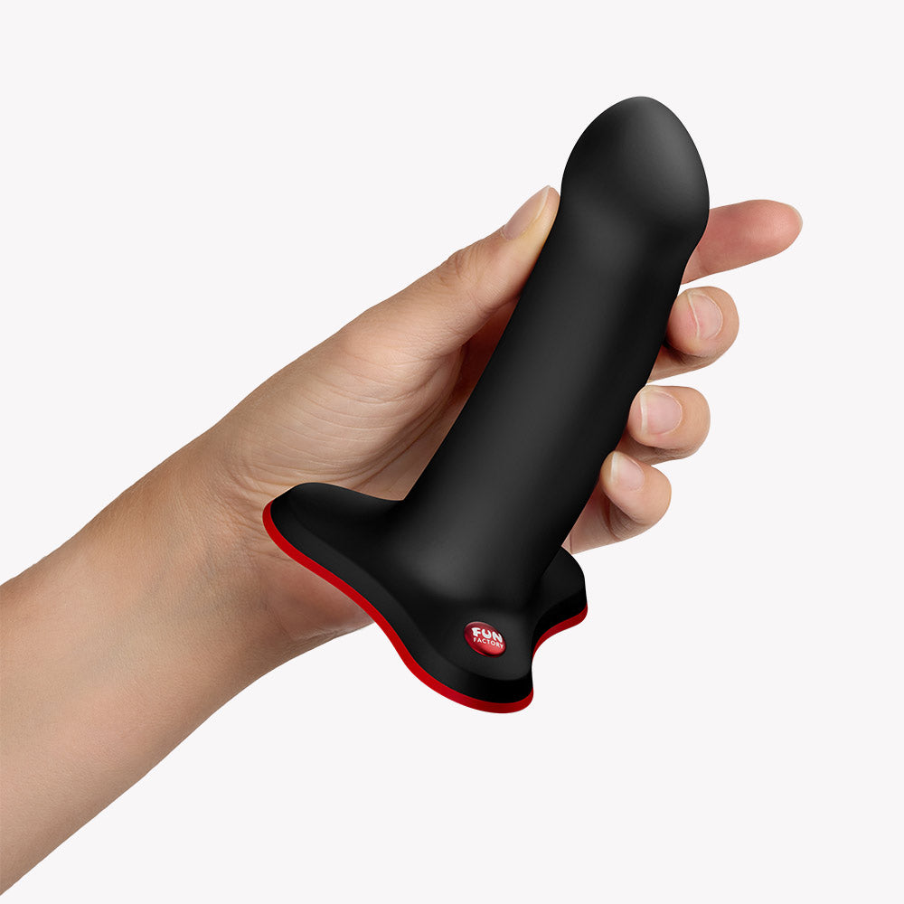 Fun Factory Amor G-Spot Dildo Black held in hand, featuring a curved design for targeted stimulation and ergonomic grip.