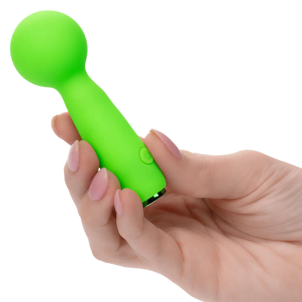 Hand holding the Neon Vibes The Bubbly Vibe mini green massager for intimate and full-body use.