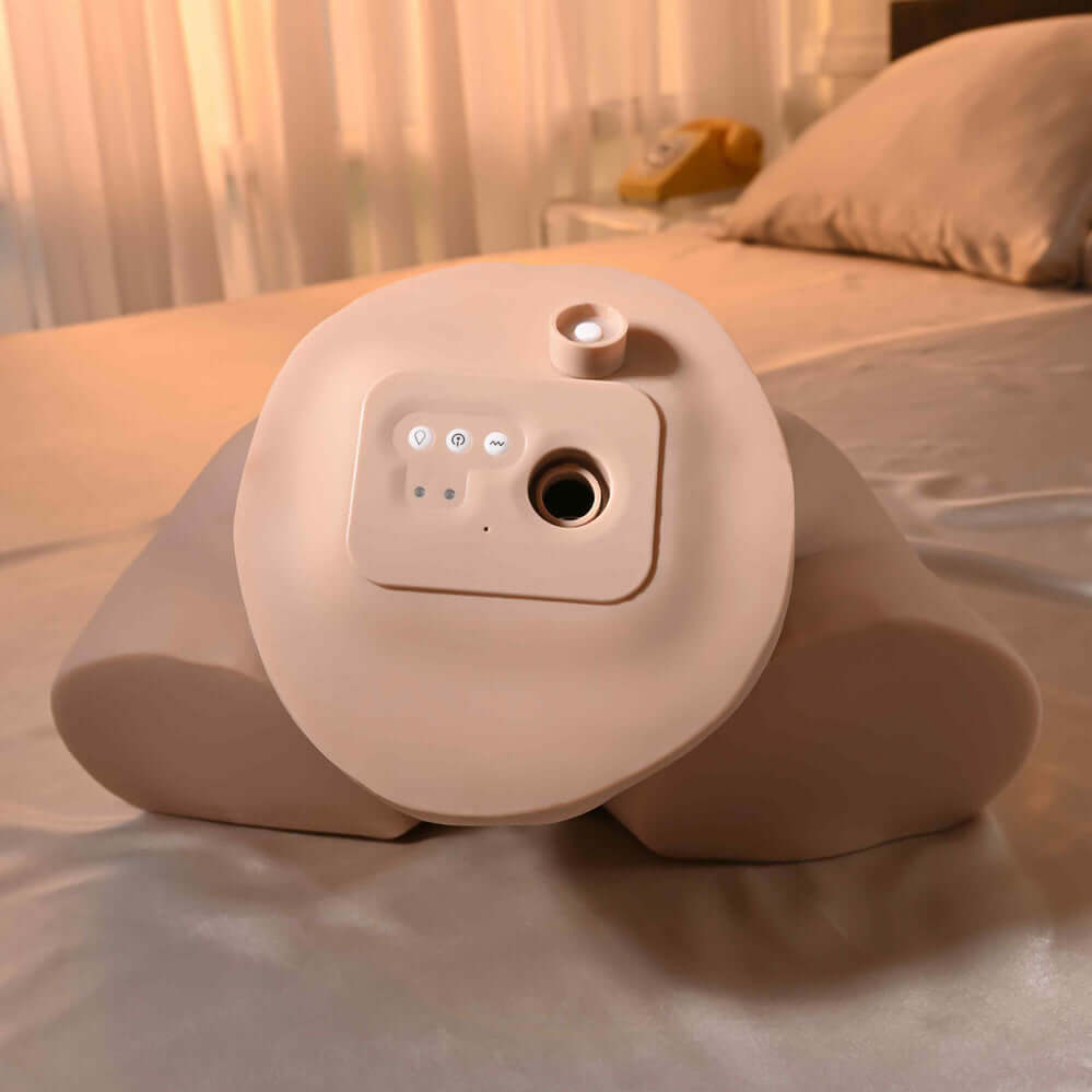 Image of the Squirt for Me XL Riley Reid Movie & Realistic Squirting Stroker on a bed, showcasing its design and features.