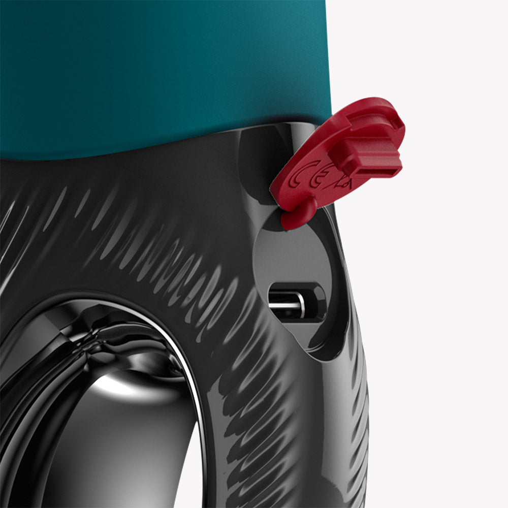 Close-up of Fun Factory Manta Vibrating Masturbator Green showing charging port and safety lock feature.