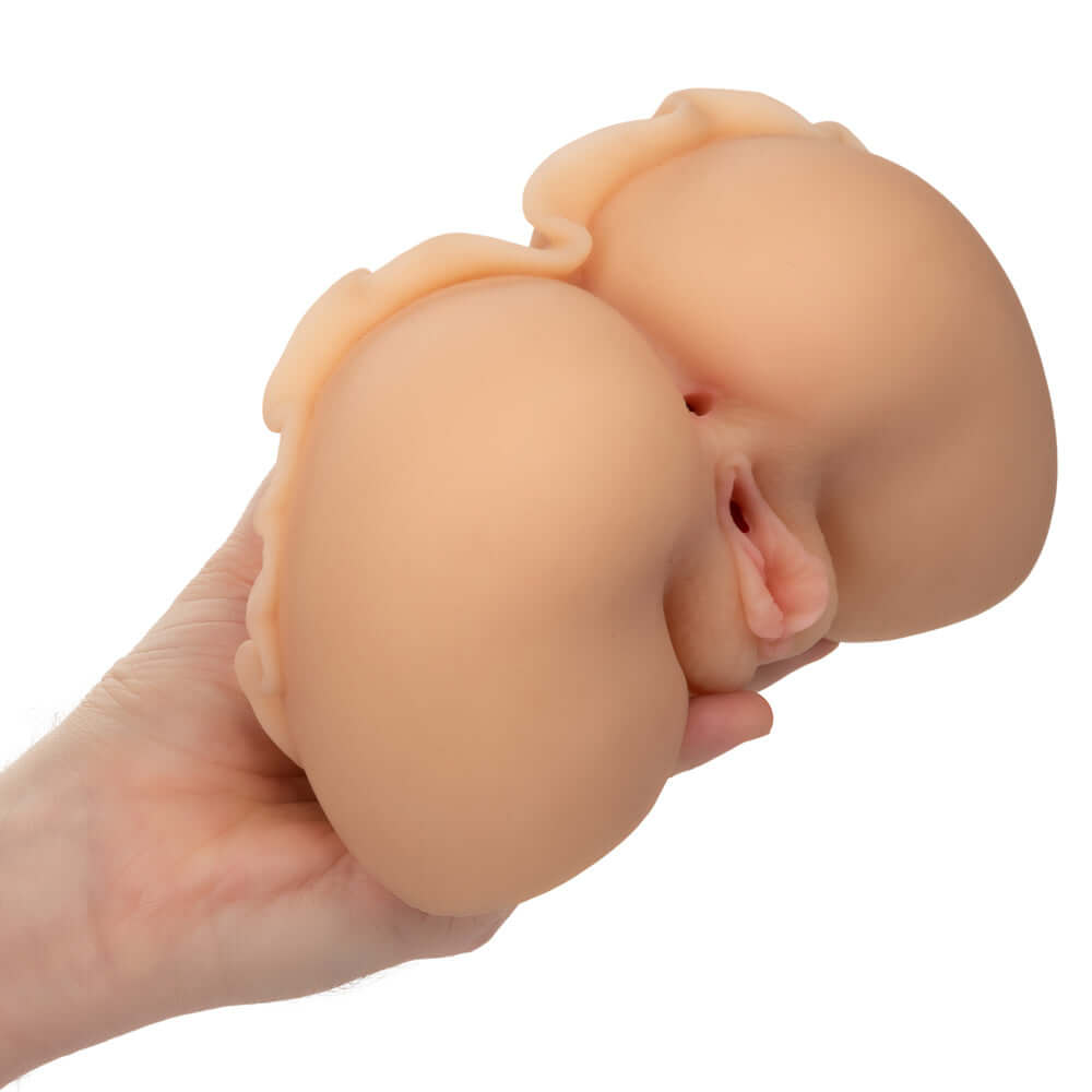 Person holding Cheap Thrills The Peep Show Girl masturbator, crafted from ultra life-like Pure Skin material with dual entry design.