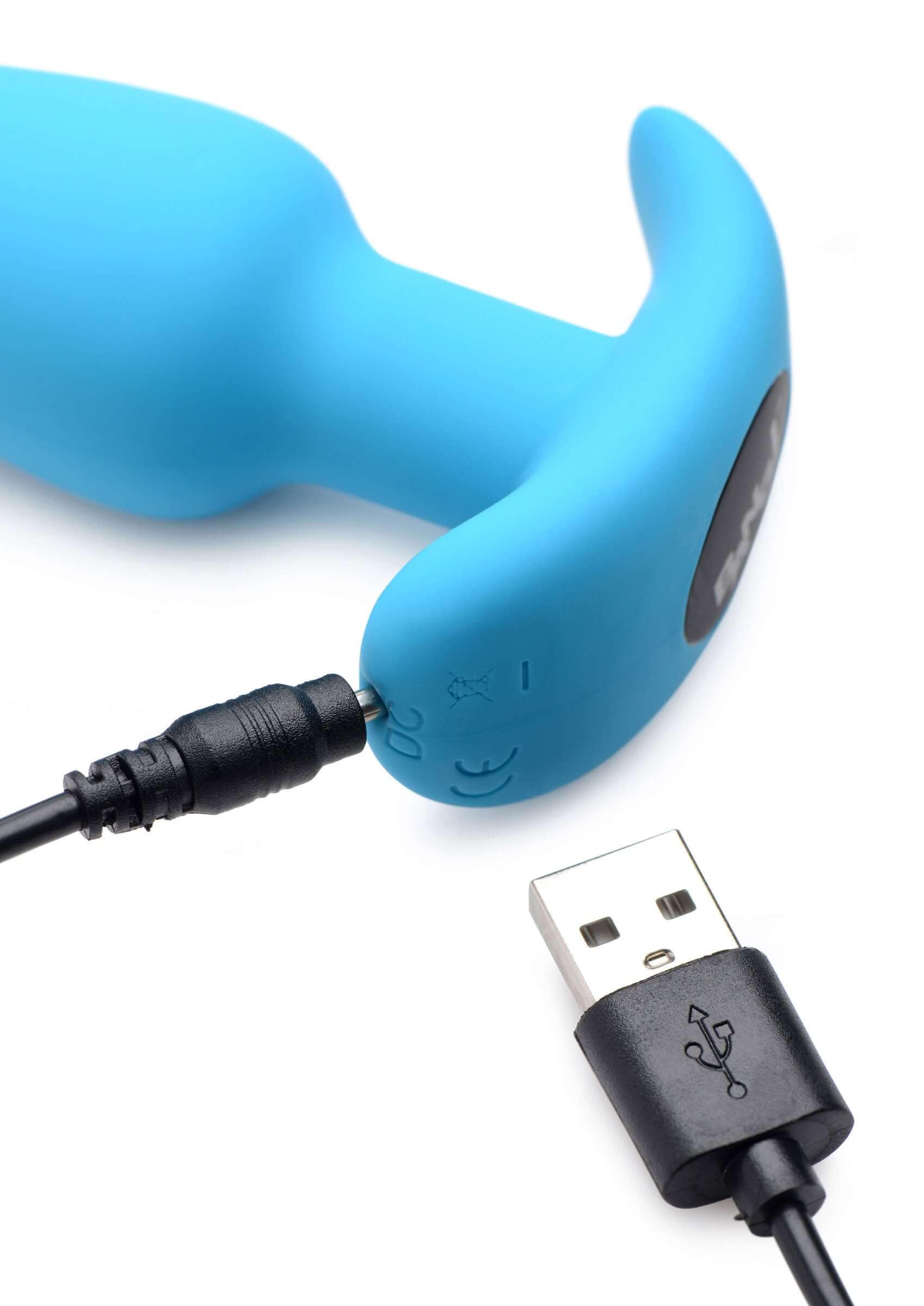 Bang 21 X Silicone Butt Plug With Remote Blue with USB charging cable connected, revealing control buttons.