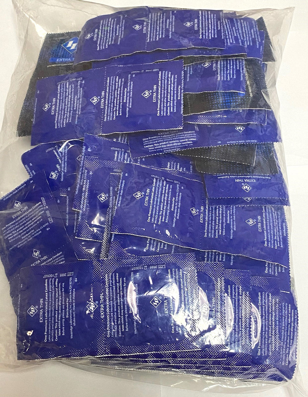 ID Extra Thin Condoms Bag 144 Pieces Bulk, showing sealed condoms for enhanced sensitivity and protection.