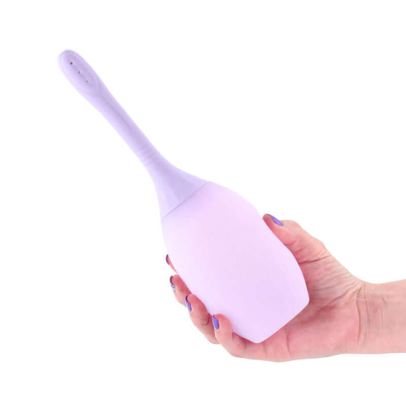 INIYA Refresh Silicone Enema Purple held in hand, designed for intimate hygiene and comfortable cleansing experience.