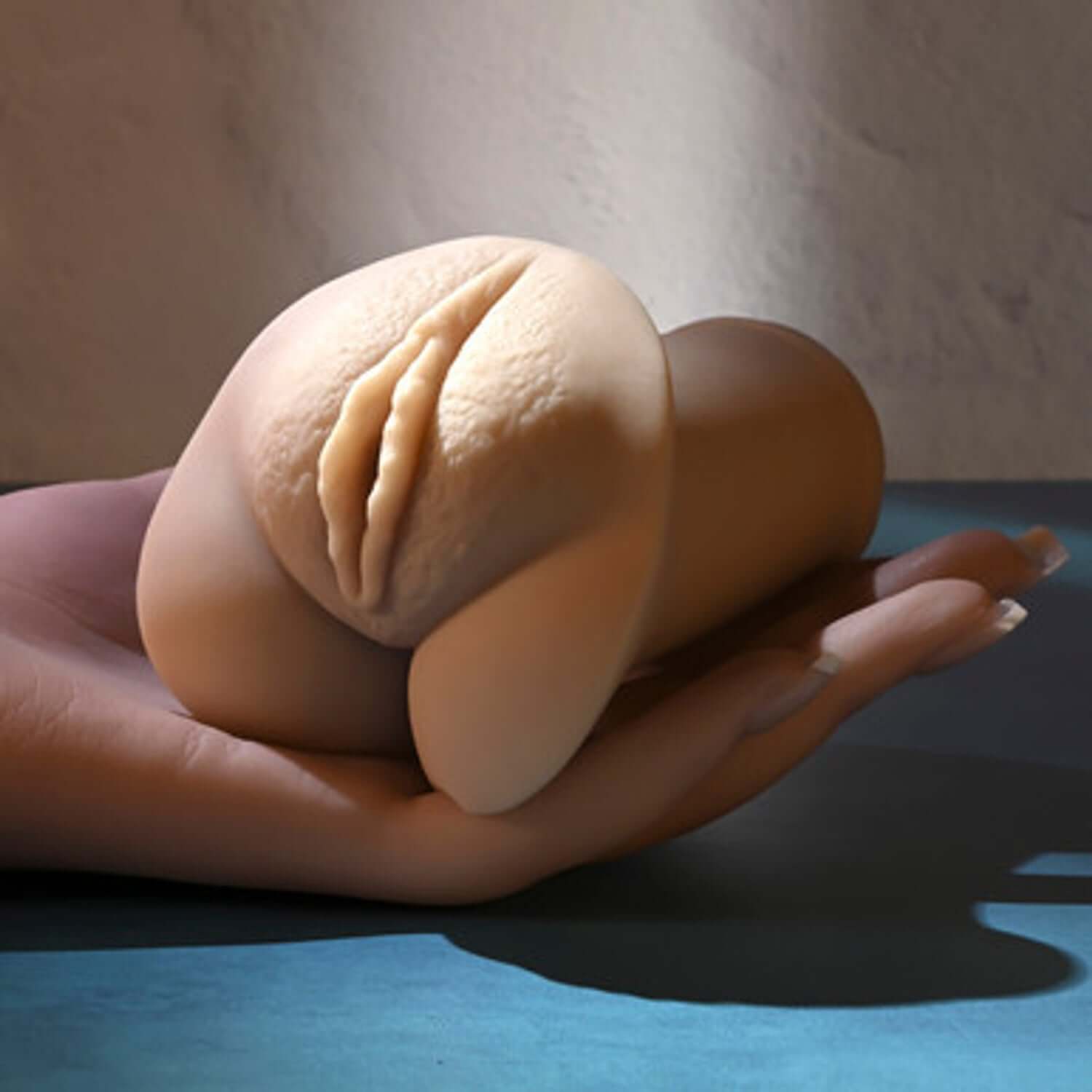Realistic pocket stroker resting in a hand, showcasing lifelike vaginal entry and soft, flexible design.