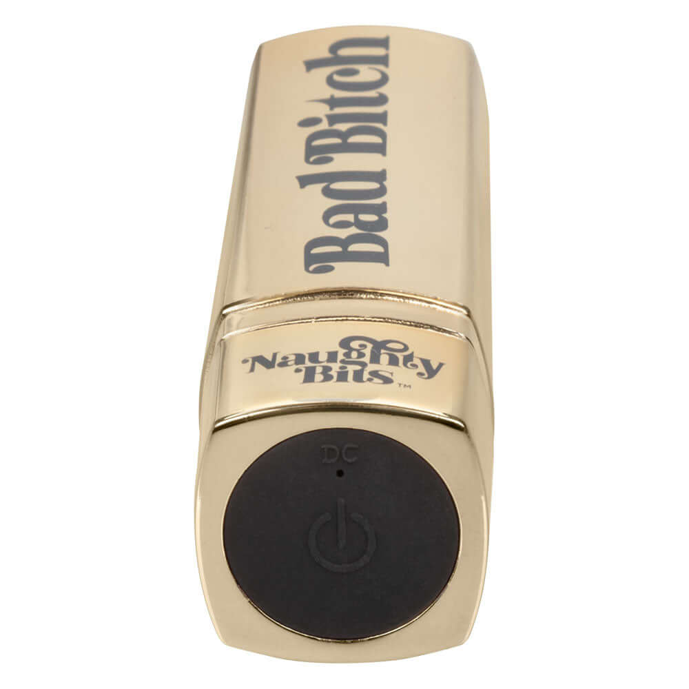 Naughty Bits Bad Bitch Lipstick Vibrator in gold with sleek design and power button, perfect for discreet pleasure.