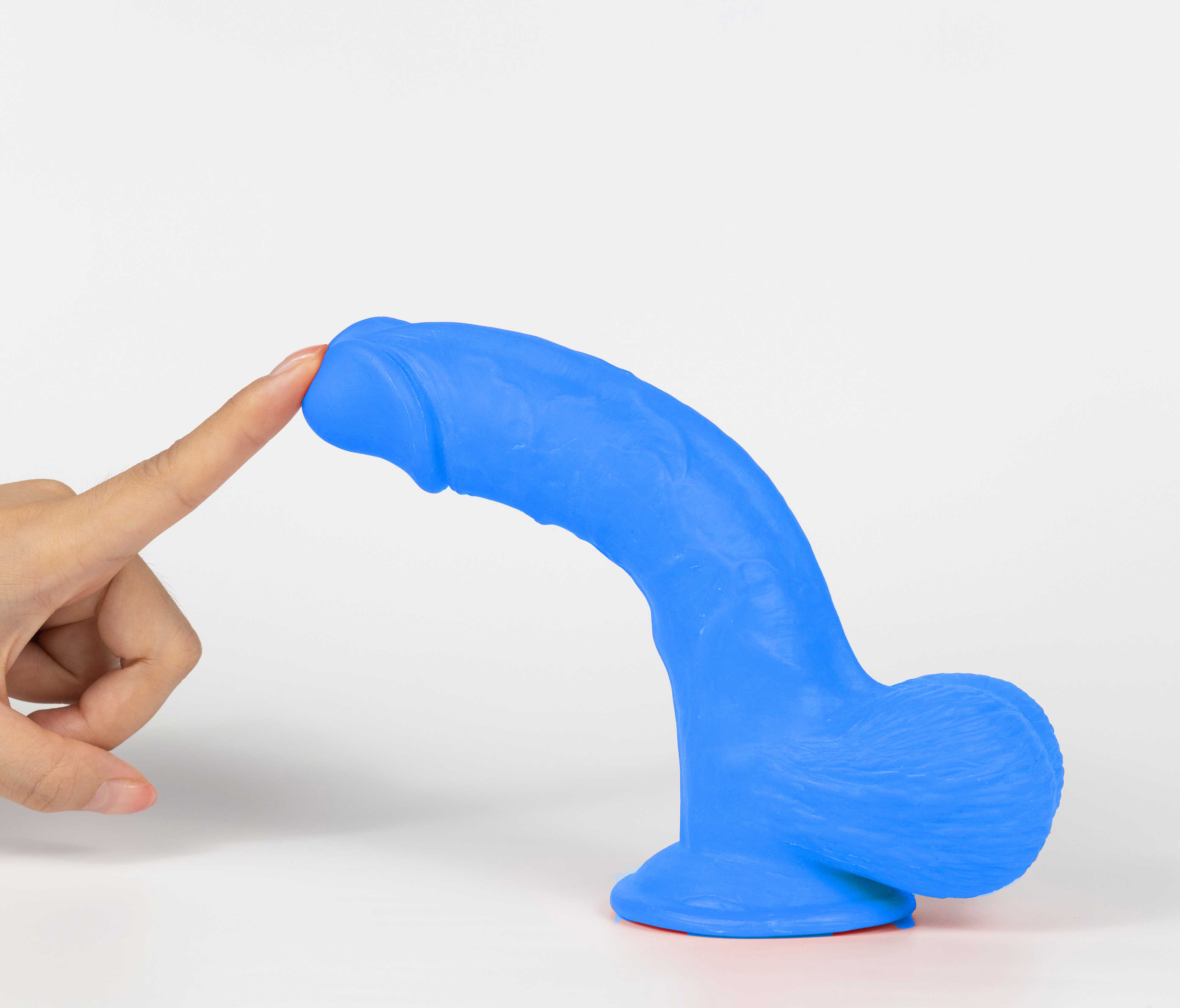 Real Skin Mr Navy 7.5 inches Dual Layer Dildo in blue with finger touching it.