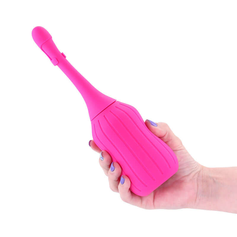 INYA Deluxe Cleanser 2.0 Silicone Enema Pink held in hand, showcasing its ergonomic design.