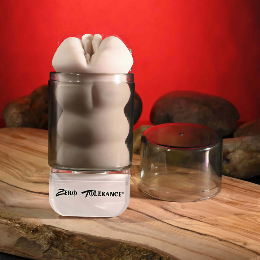 Riley Reid Movie With Mini Vagina Stroker shown in a clear container on a wooden surface.