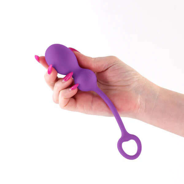 Techno Bop Rechargeable App Compatible Vibrator Purple held in hand showcasing its sleek design.
