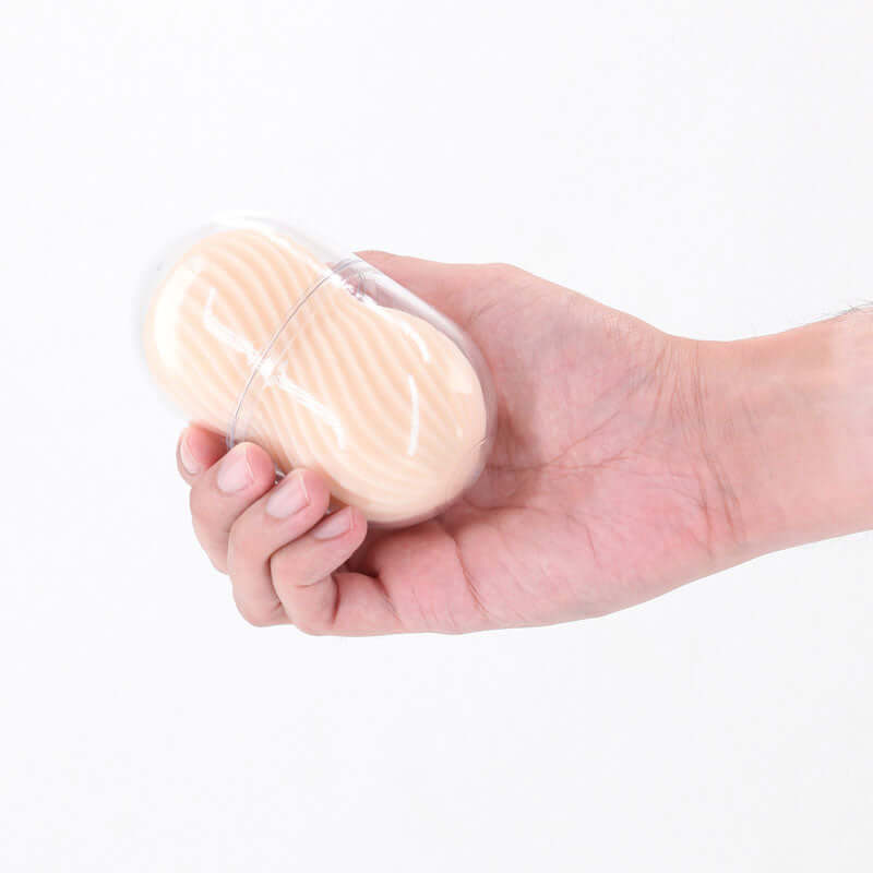 A hand holding the Pocket Pals Handy Strokers Misty White, showcasing its compact design and textured sleeve.