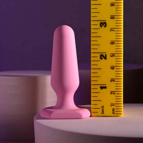 Selopa Petite Plug - Pink silicone anal plug next to a ruler for size reference, height: 2.89"