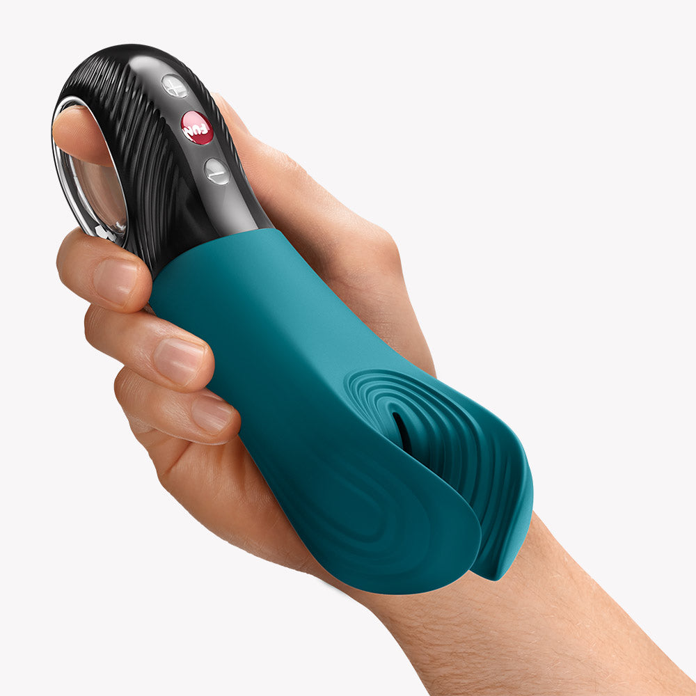 Fun Factory Manta Vibrating Masturbator Green held in hand, showcasing its ergonomic design and flexibility.