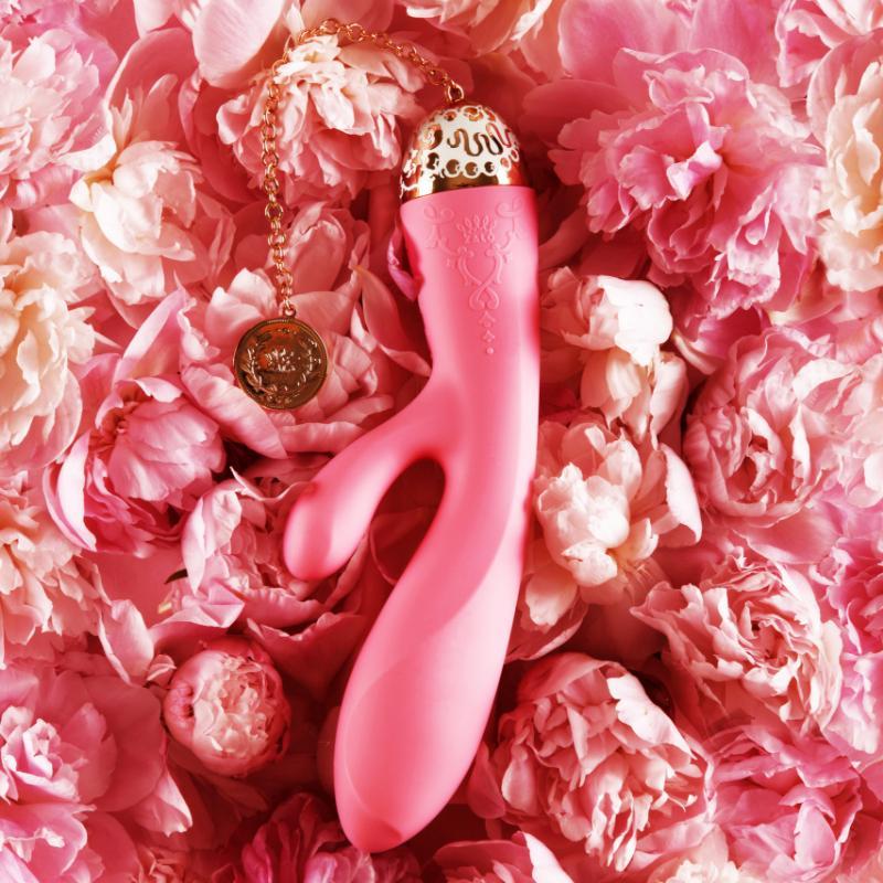 ZALO Rosalie Rabbit Vibrator in Rouge Pink surrounded by pink flowers from the Versailles Series