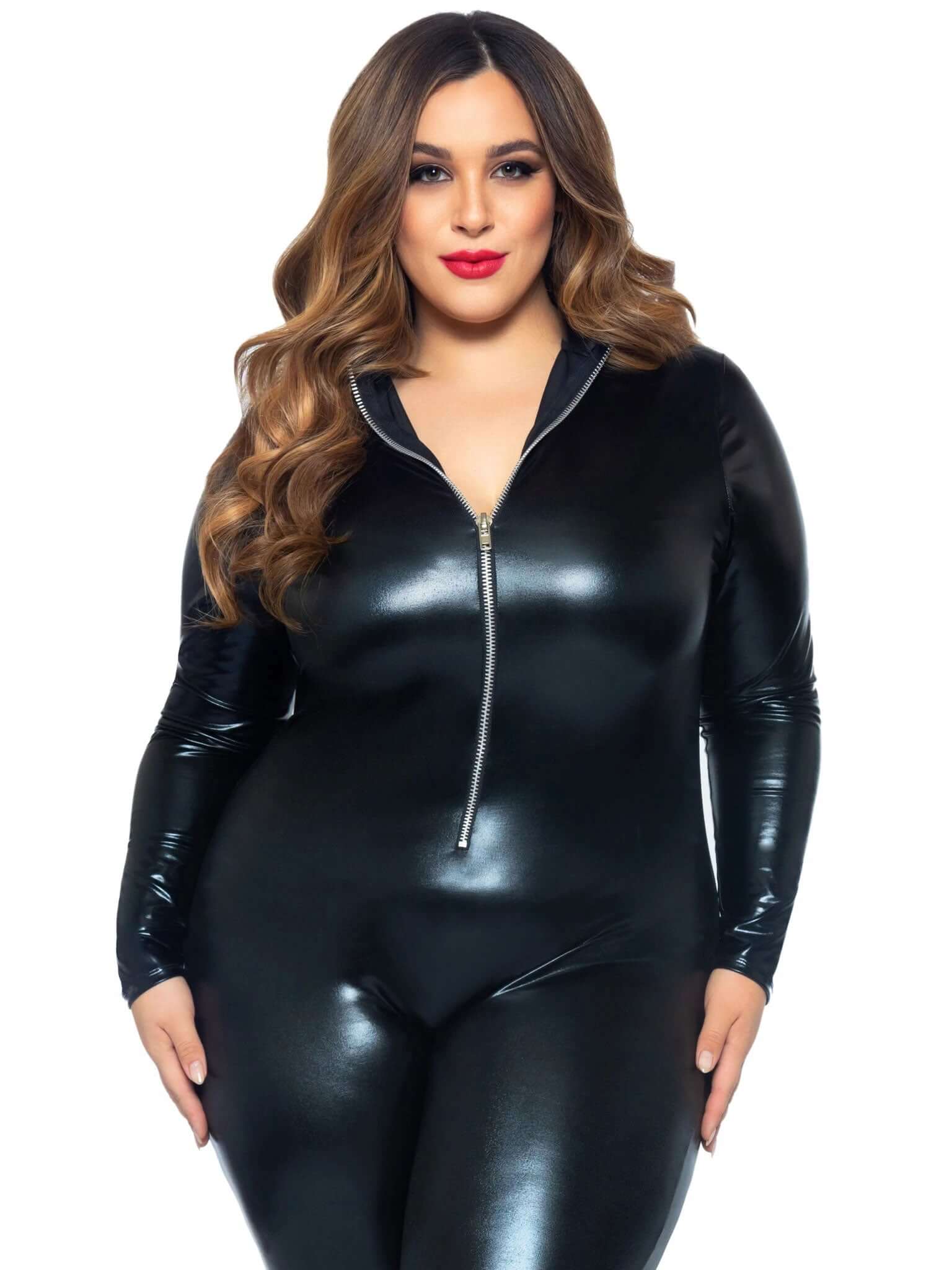 Plus size model wearing sleek black lamé zipper front catsuit with long sleeves, showcasing femme fatale style and flattering fit.