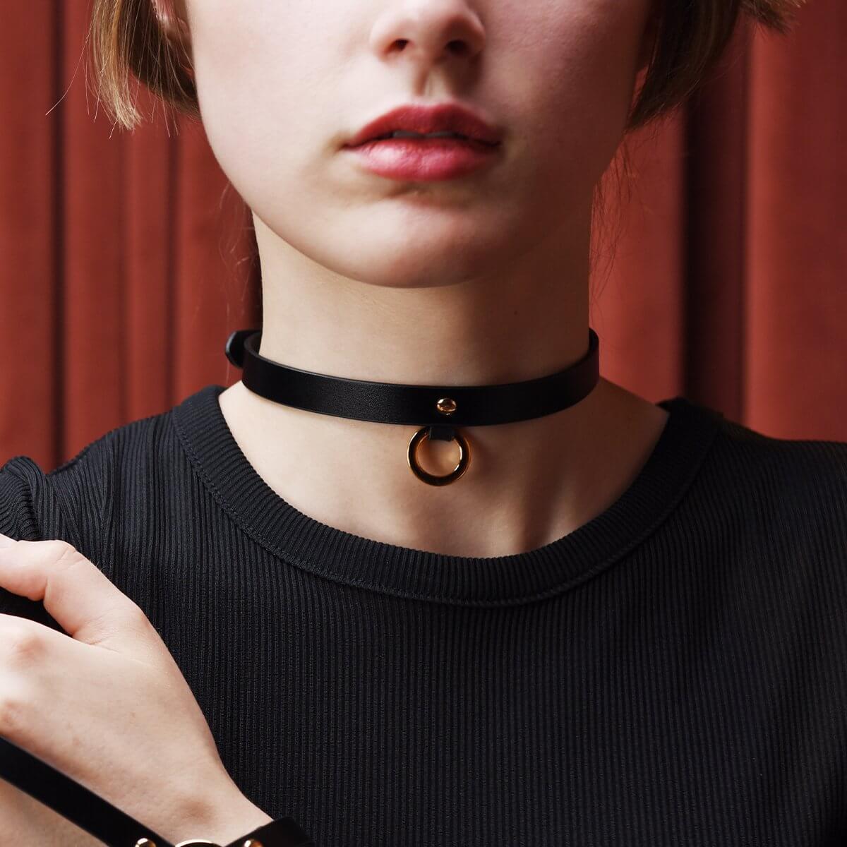 Model wearing UPKO Luxury Italian Leather Thin Black Choker, showcasing elegant design with gold ring detail.