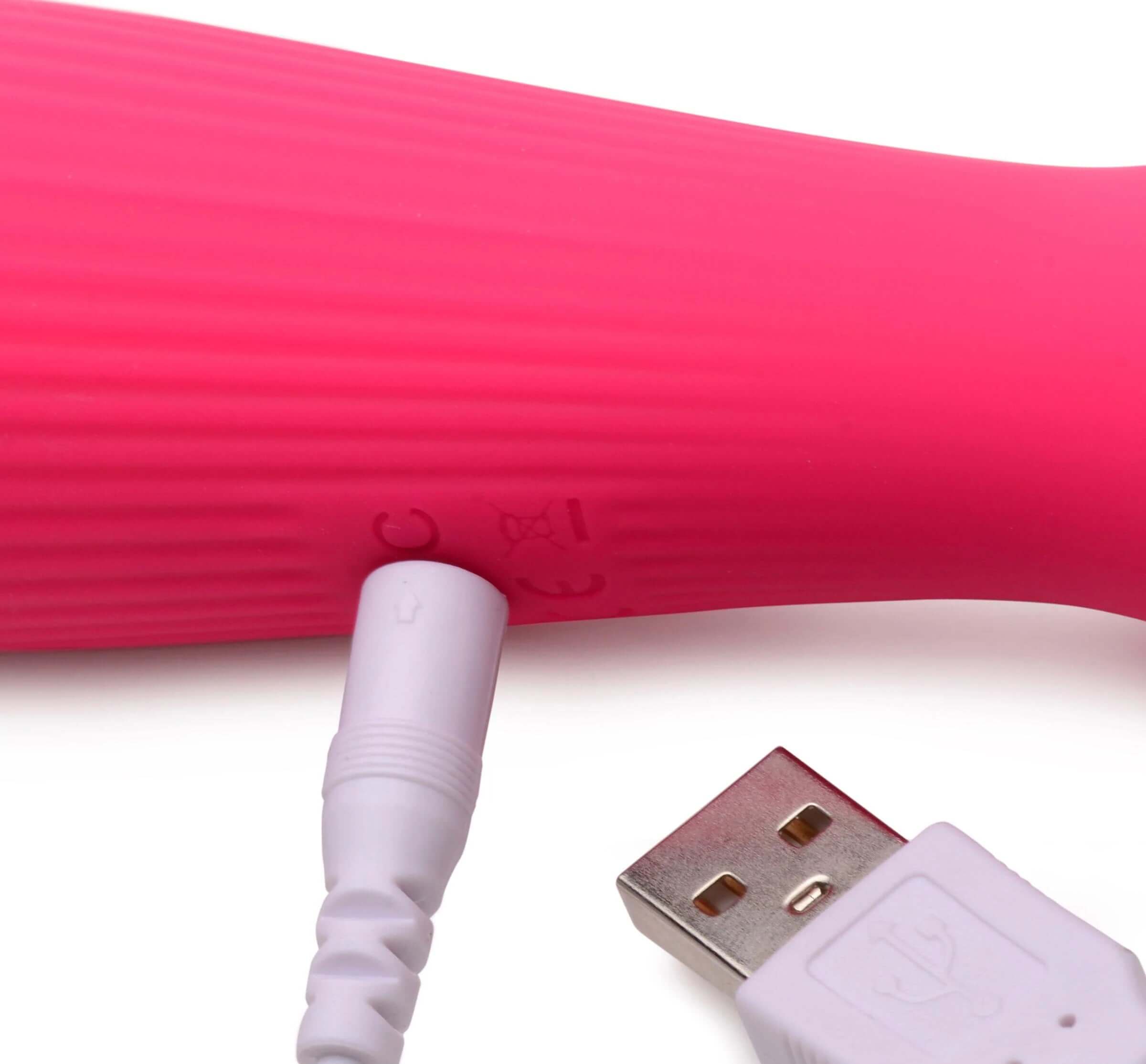 Charging port and cable of magenta silicone wand massager with textured body