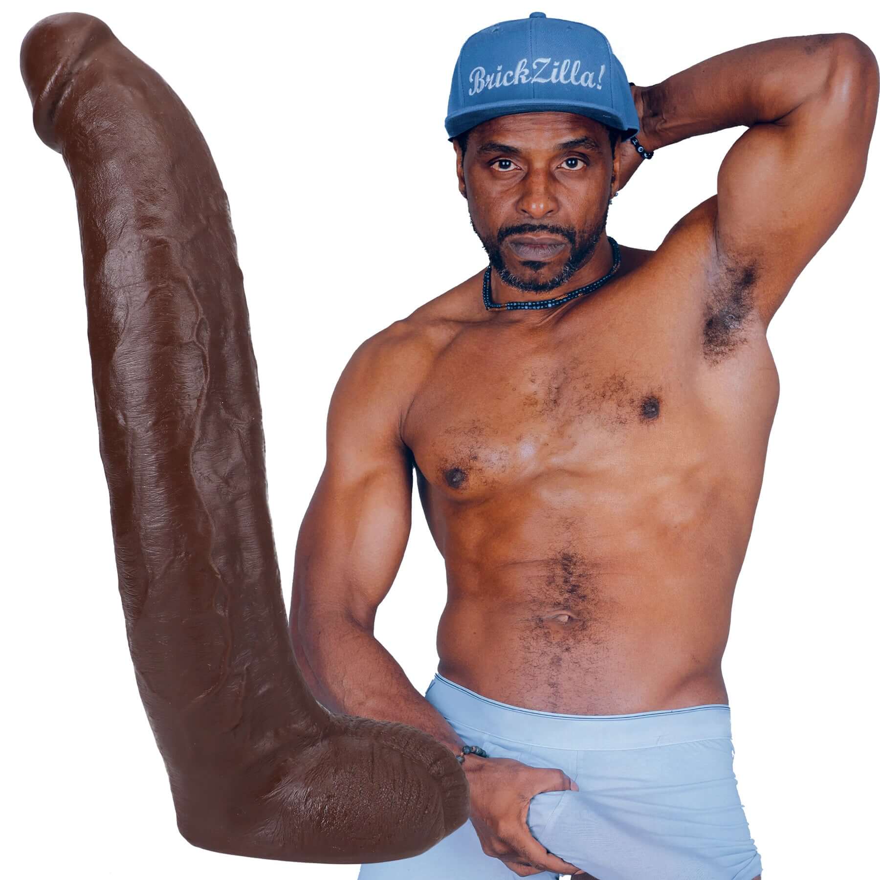 Brickzilla holding 13 inch chocolate ULTRASKYN cock with veined texture and removable Vac-U-Lock suction cup