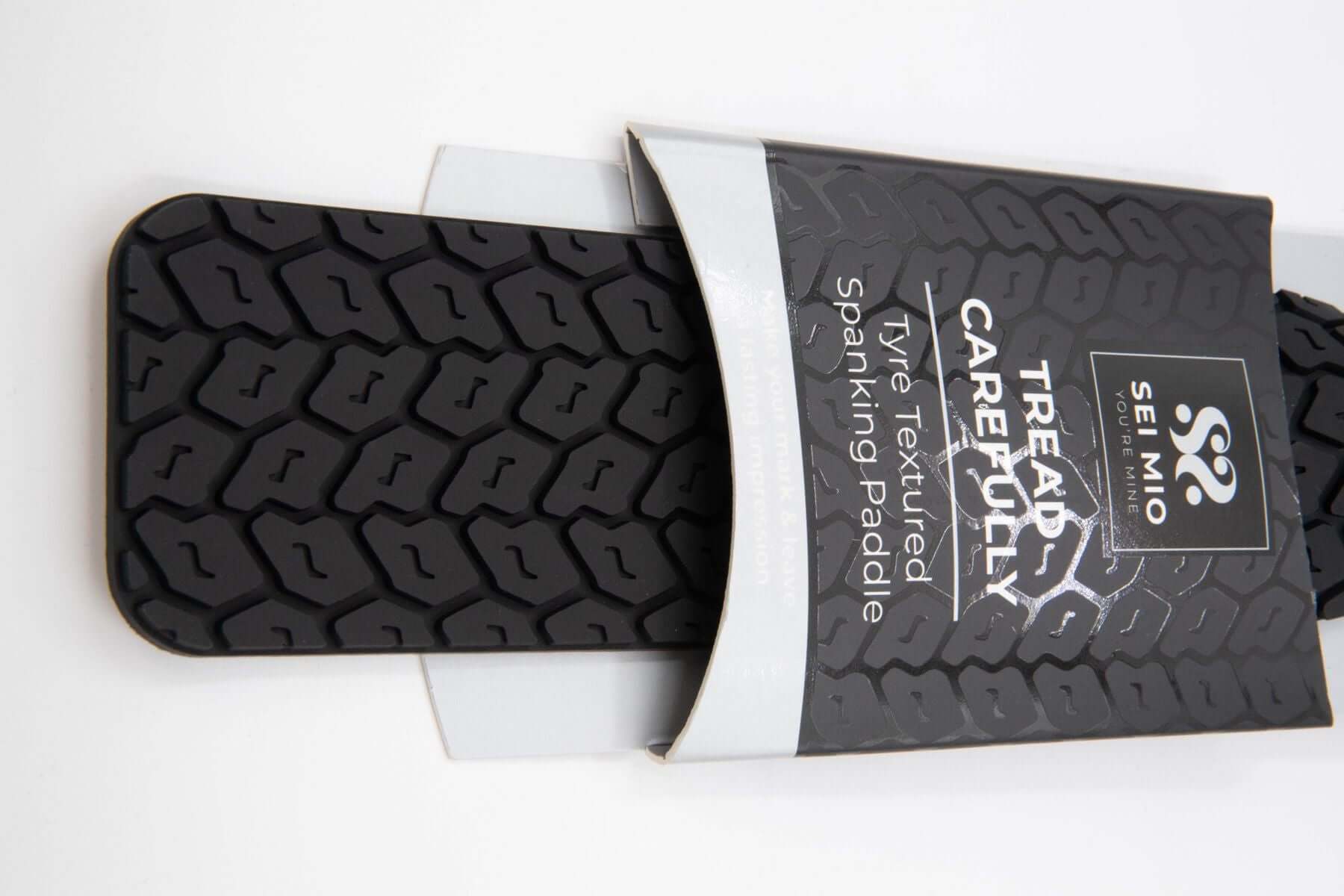 Sei Mio Tread Carefully Tyre Paddle Black displayed with double-sided textured surfaces for customizable sensations.