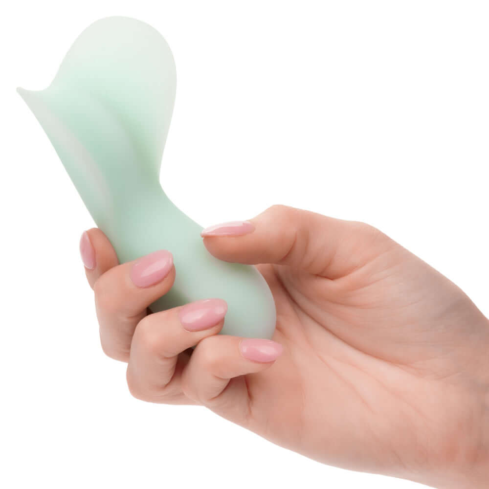 Hand holding Pacifica Tahiti Massager in green, showcasing its contoured shape for maximum stimulation and luxurious sensation.