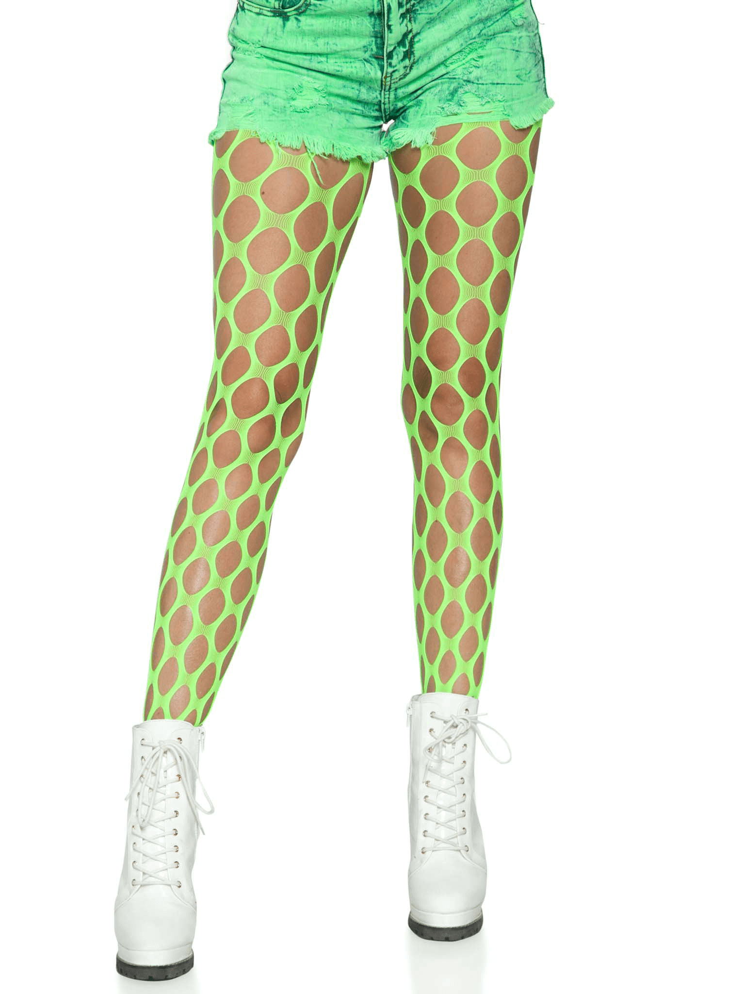Neon green jumbo pothole net tights paired with distressed green shorts and white boots for an edgy look